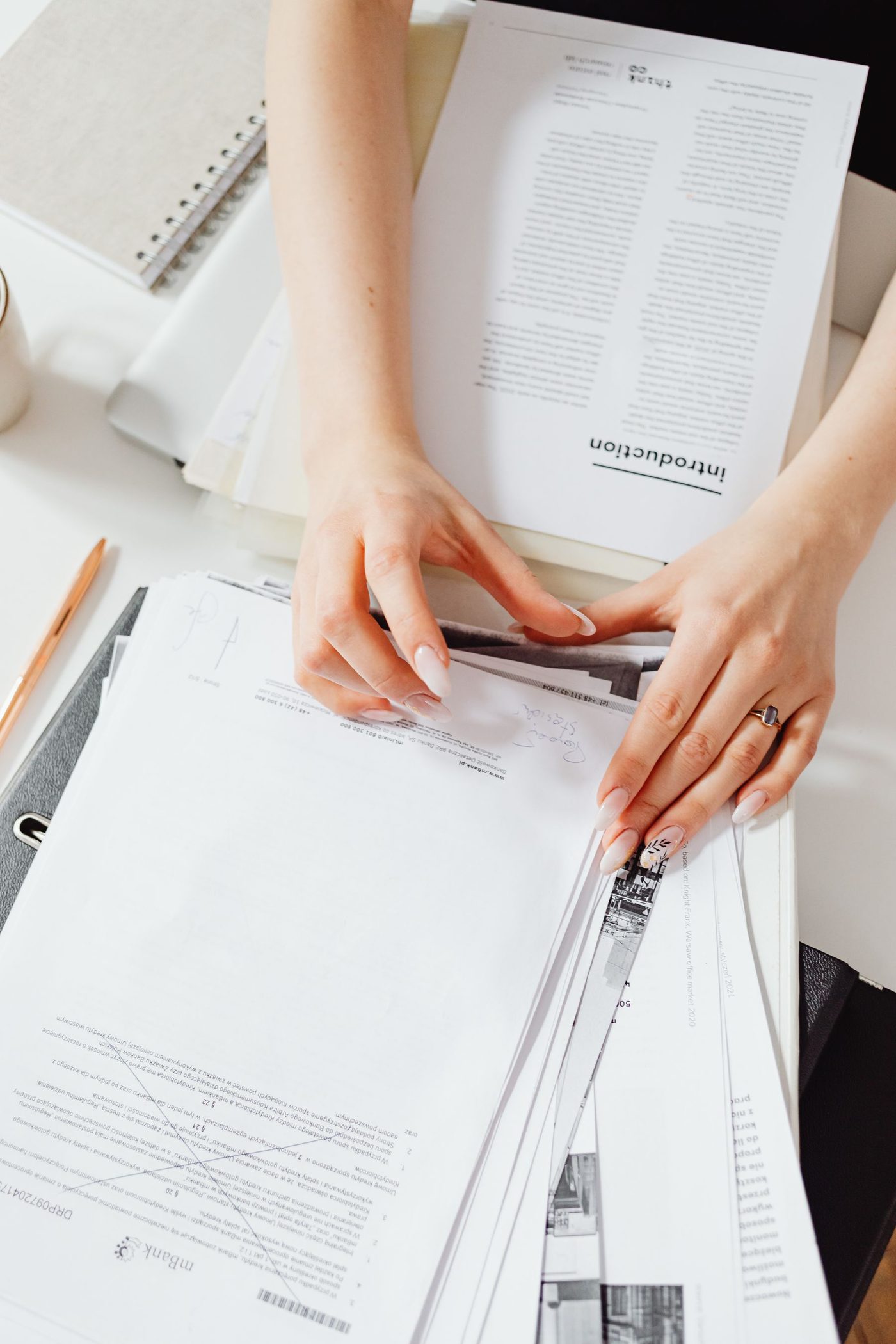 Hands organising paperwork efficiently at a desk