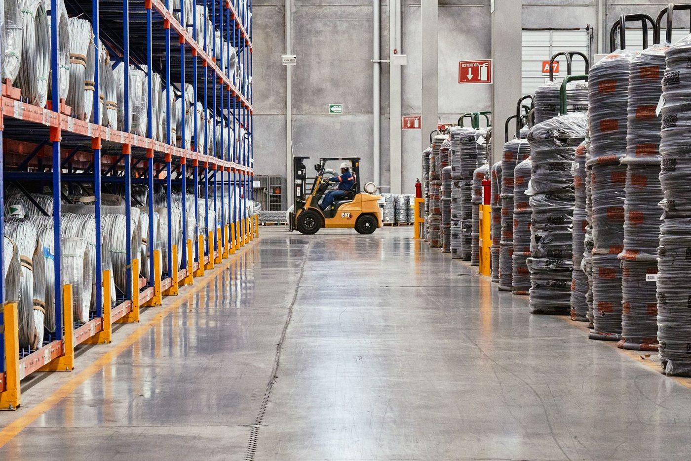 Warehouse aisle with racking and a forklift
