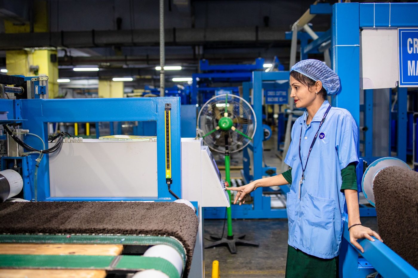 Worker operating machinery on a modern factory line